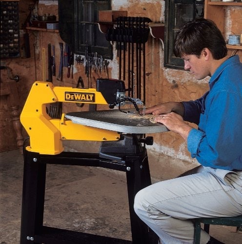 a man using a scroll saw