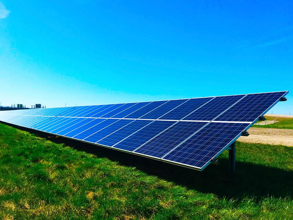a row of solar panels installed in the field