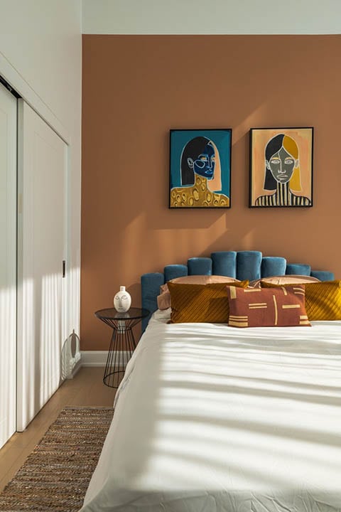bed with blue tufted headboard