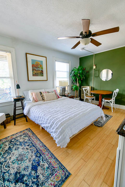 bedroom with bold blue rug