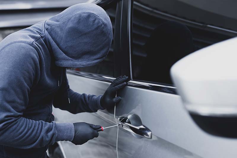Car thief hand holding screwdriver