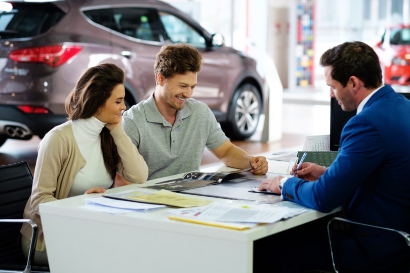 couple at the car dealer showroom