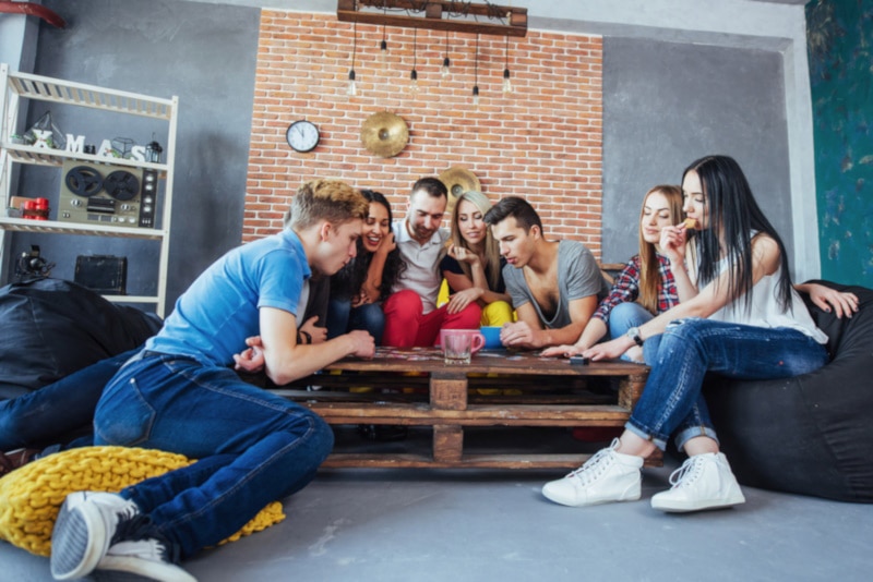 Friends playing board game at table