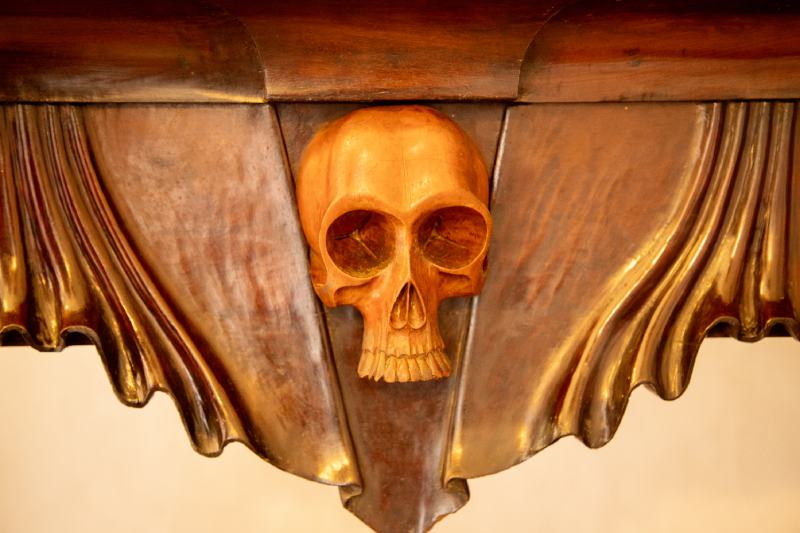 Gilded wood carved skull on wall