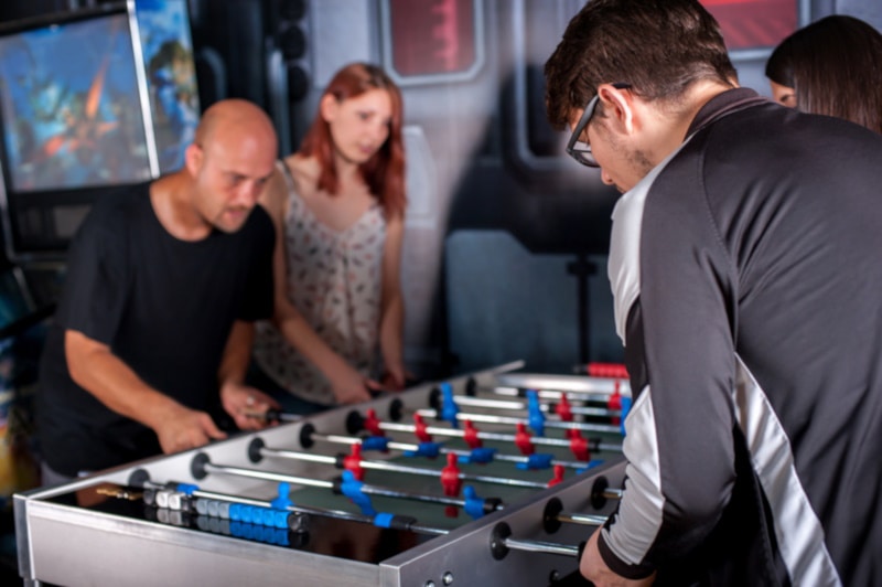 Group of friends playing fooseball