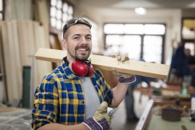 handyman carrying wood