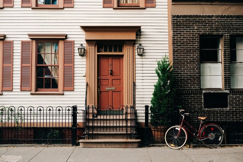 house on the sidewalk with vinyl siding