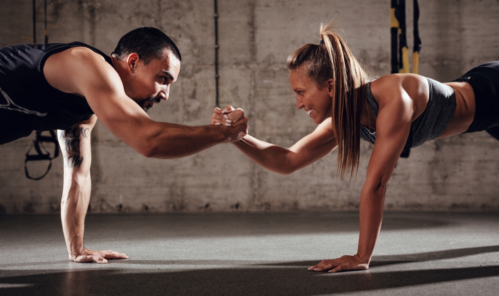 man and woman working out on the gym
