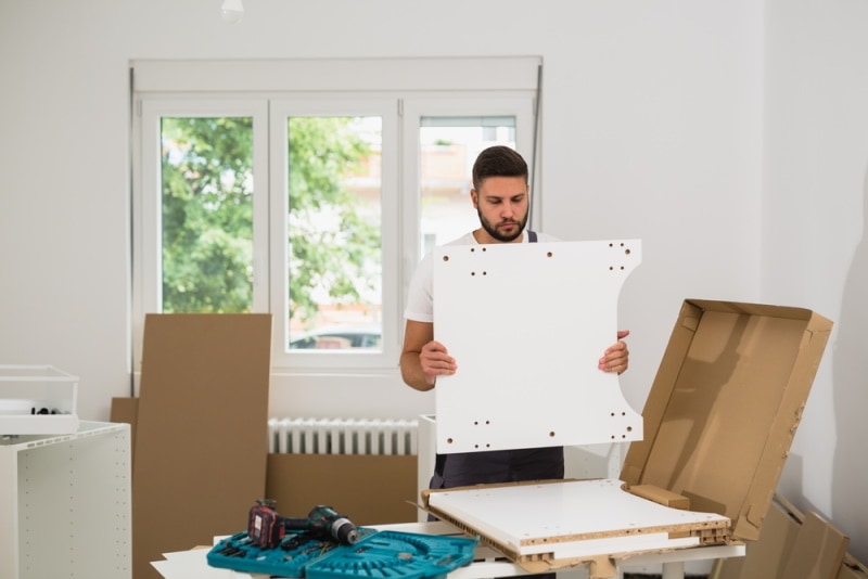 man assembling kitchen cabinet
