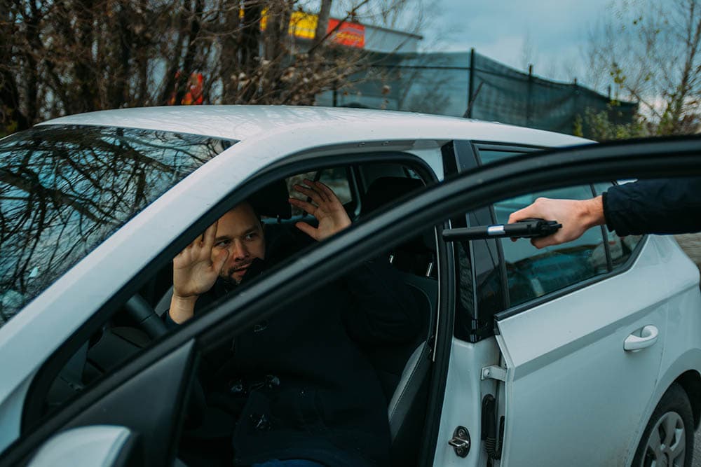 man being carjacked