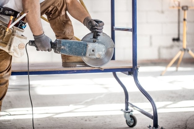 man cutting using angle grinder