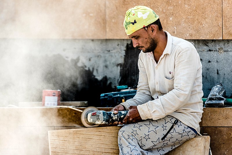 man cutting wood with angle grinder