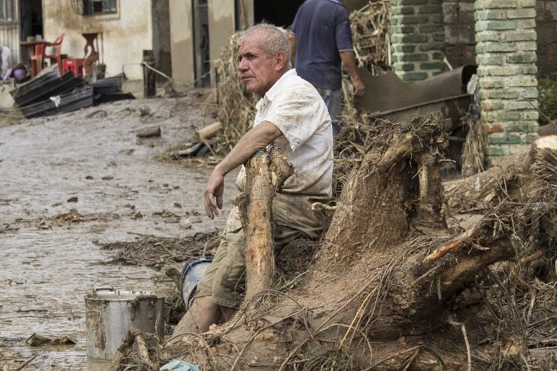 man devastated by the flood