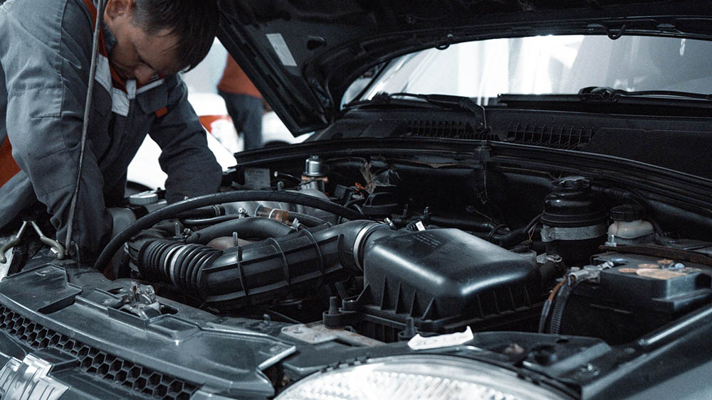man doing car maintenance check