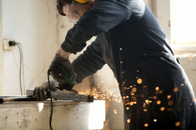 man grinding with angle grinder