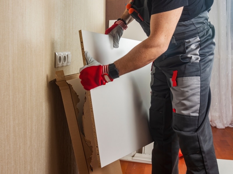 man holding furniture board
