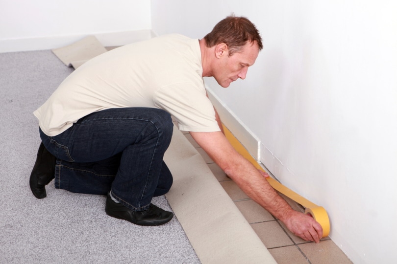 man installing carpet