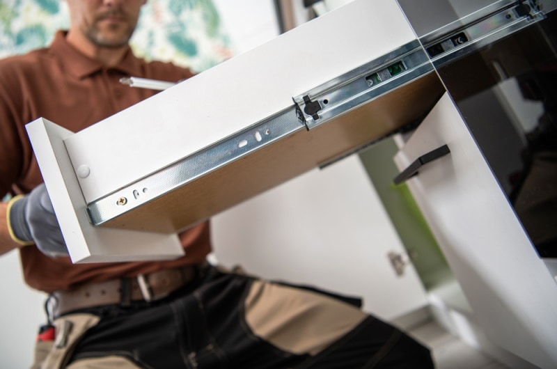 man installing drawer