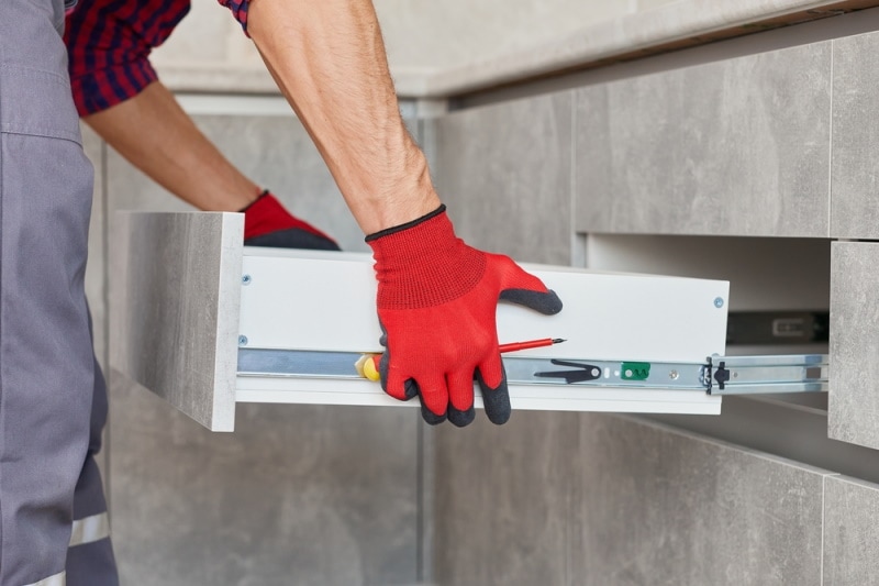 man installing drawer