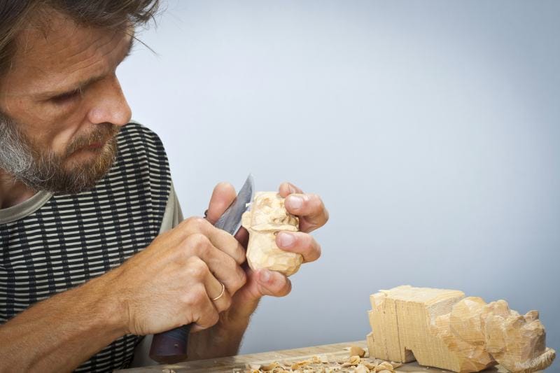 man is keen on woodcarving