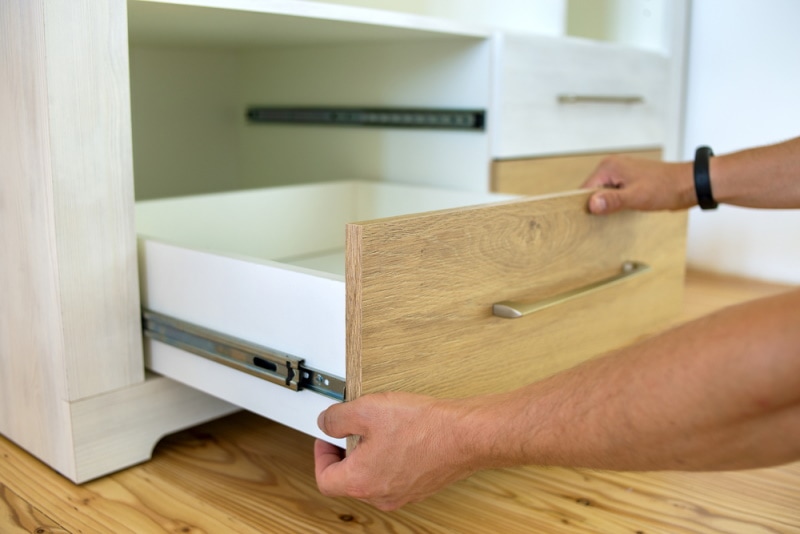 man pulling out drawer