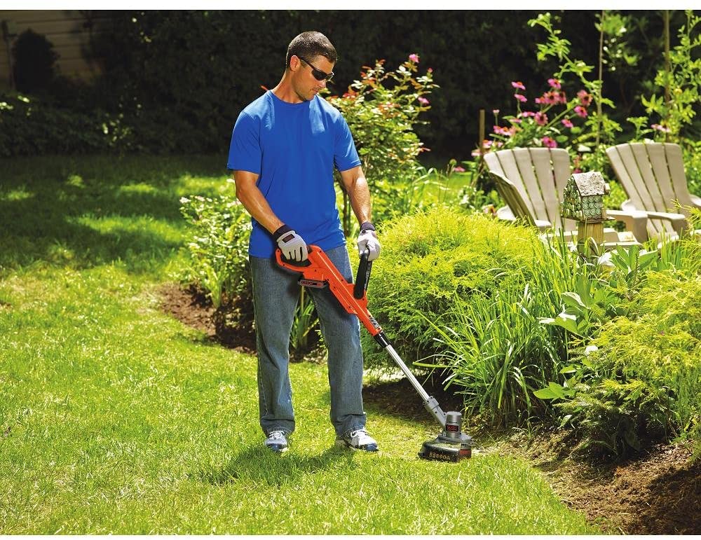 man using BLACK+DECKER LST300 Weed Whacker