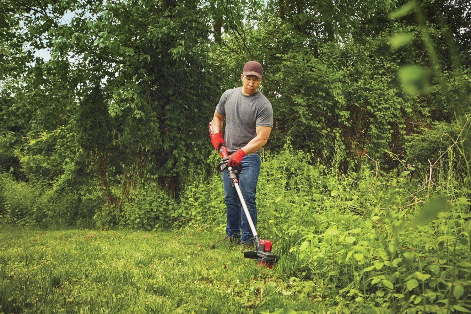 man using CRAFTSMAN CMCST960E1 WEEDWACKER
