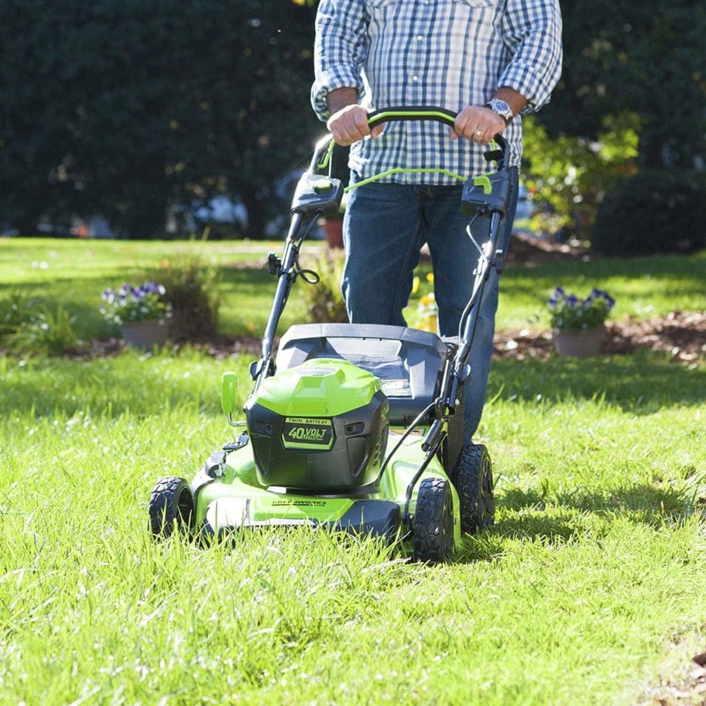 man using Greenworks M-210-SP Self-Propelled Mower