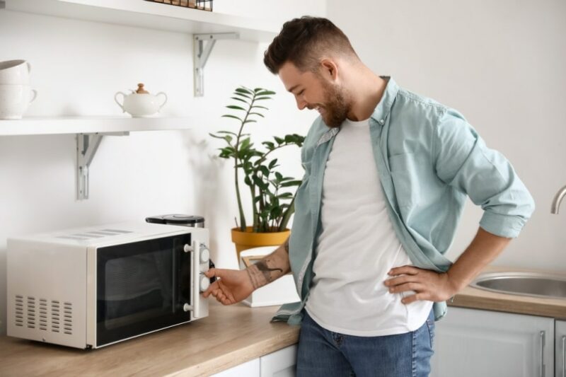 man using microwave