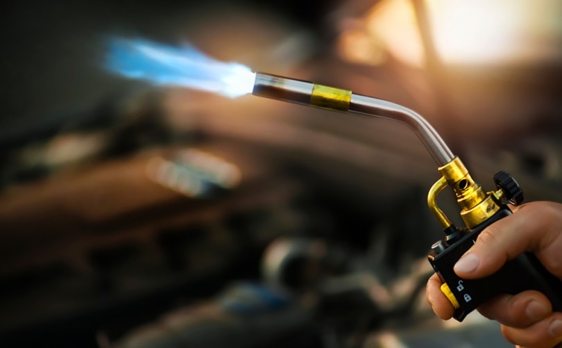 man using torch burner