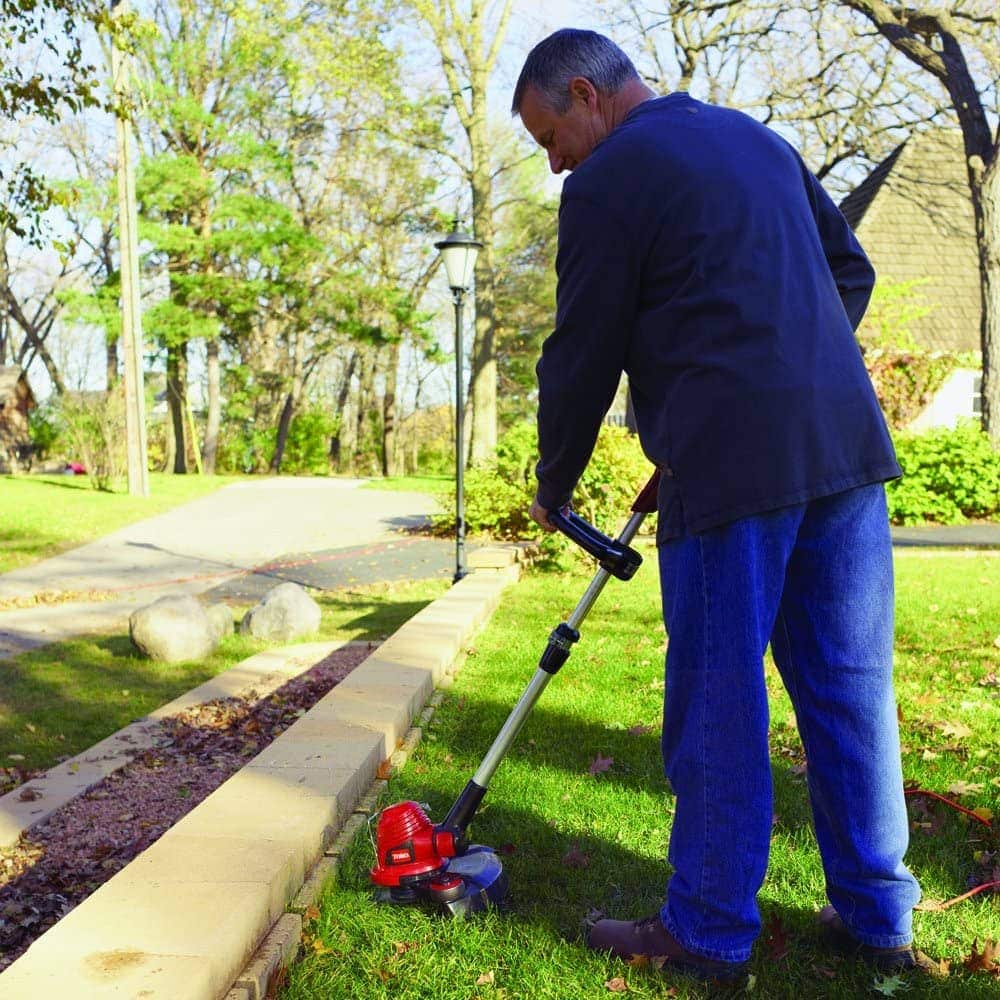 man using Toro 51480 Corded Electric Trimmer