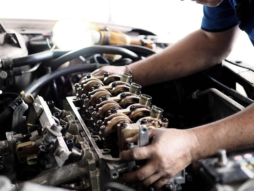 mechanic removing car engine