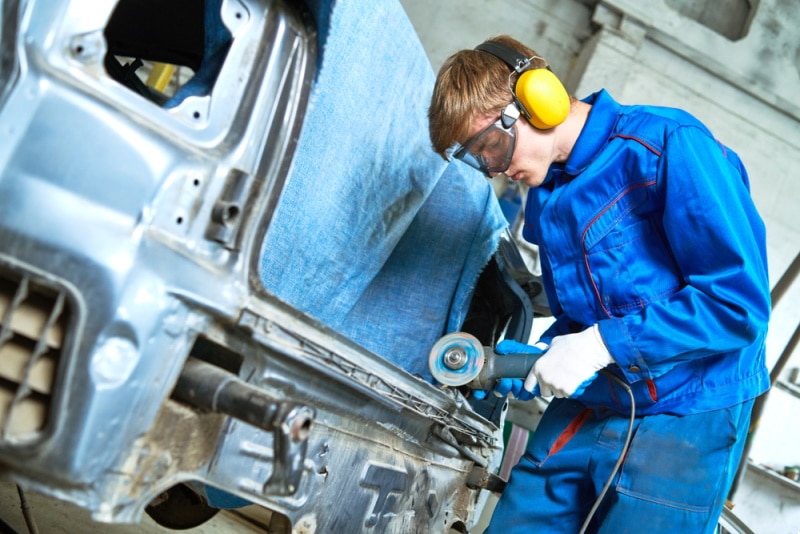 mechanic working on car body