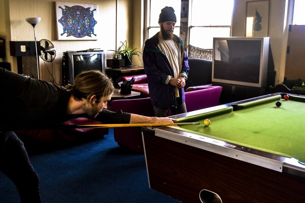 men playing billiards at home