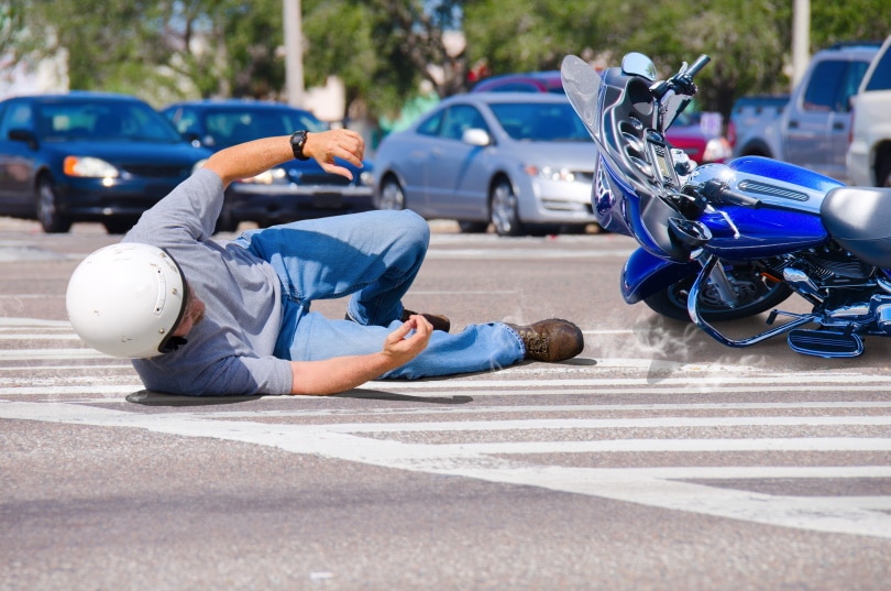 motorcycle rider lying on the road