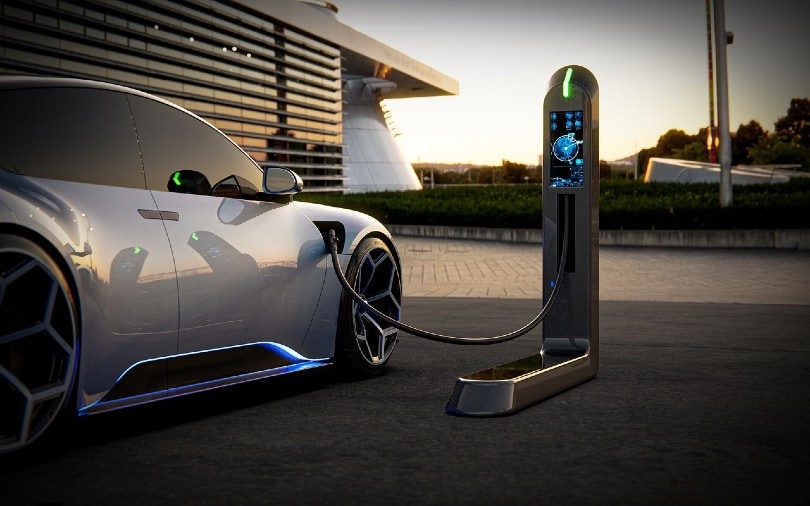 new silver electric car at a charging station