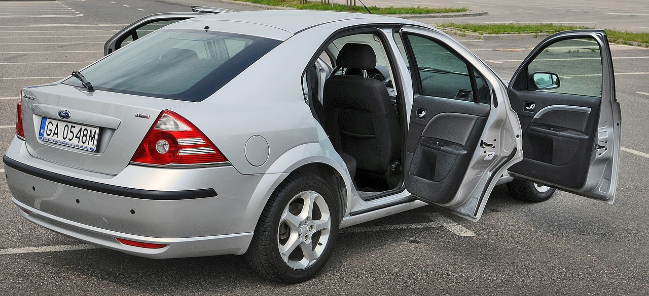 open regular car doors of grey car