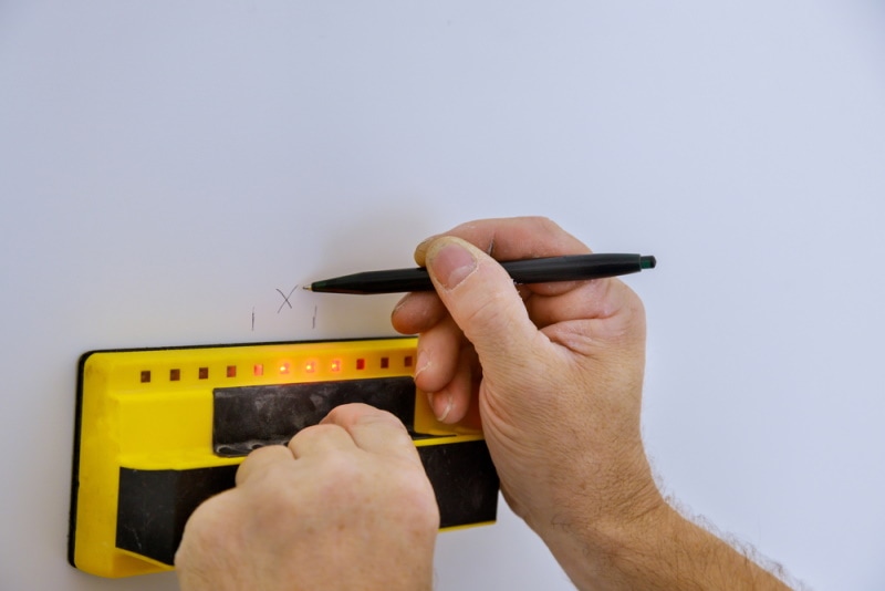 Person using a digital stud finder