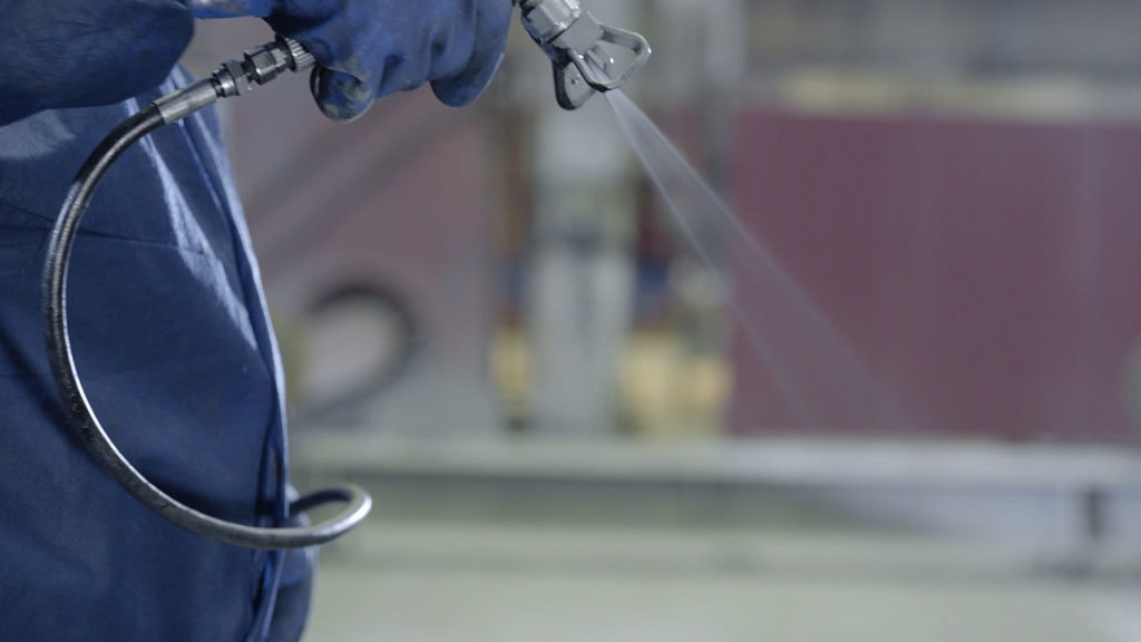 person using air compressor as pressure washer