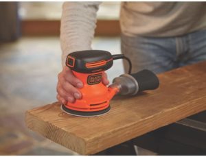 person using BLACK+DECKER BDERO100 Random Orbit Sander