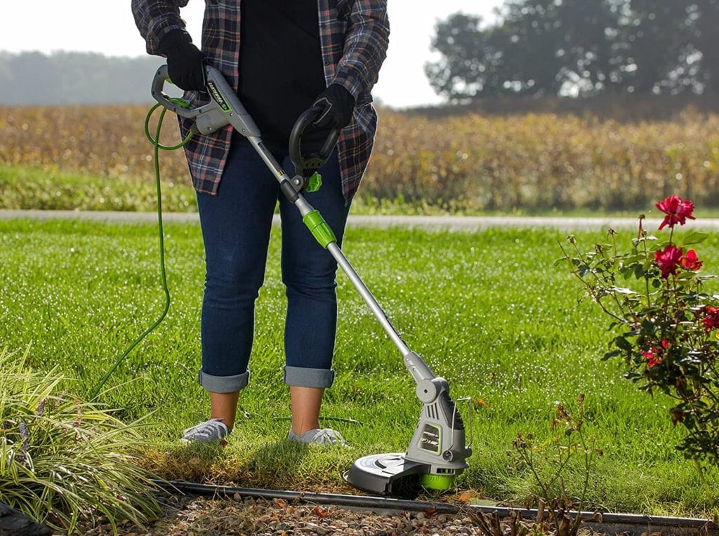 person using Earthwise ST00115 15-Inch 5-Amp Corded Electric String Trimmer