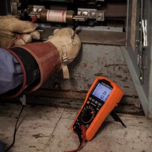 person using Klein Tools MM700 Multimeter