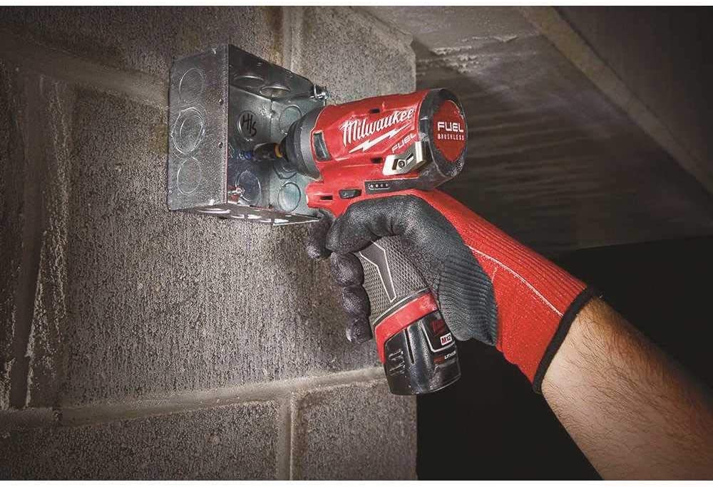person using Milwaukee 2553-22M12 Fuel Hex Impact Driver
