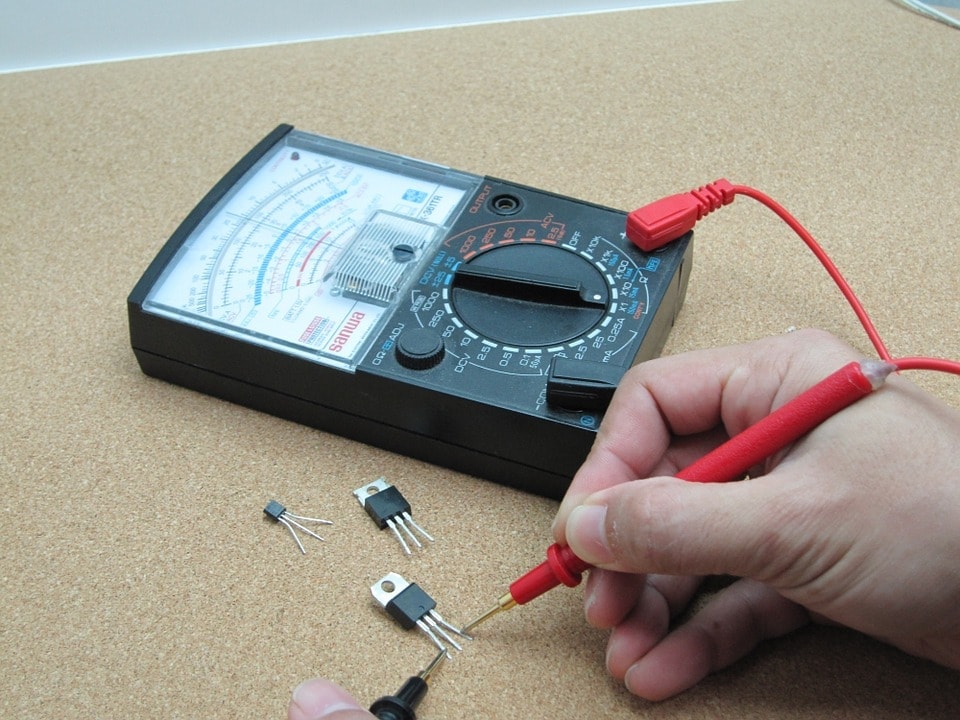 person using multimeter