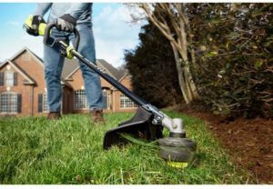 person using RYOBI 40-Volt Lithium-Ion Cordless Attachment Capable String Trimmer