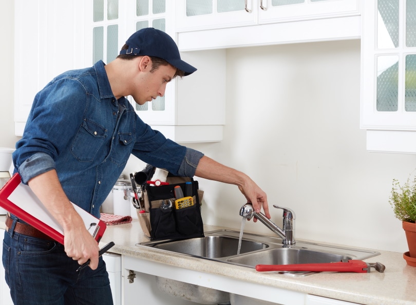 plumber checking faucet