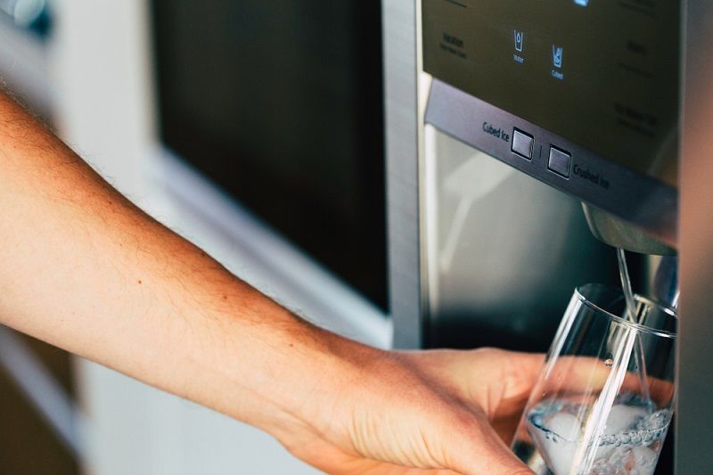 pouring cold water and ice cubes from dispenser_cegli_shutterstock