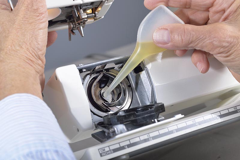 putting oil on sewing machine