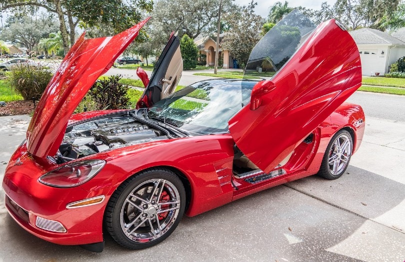 red sportscar with open hood and doors
