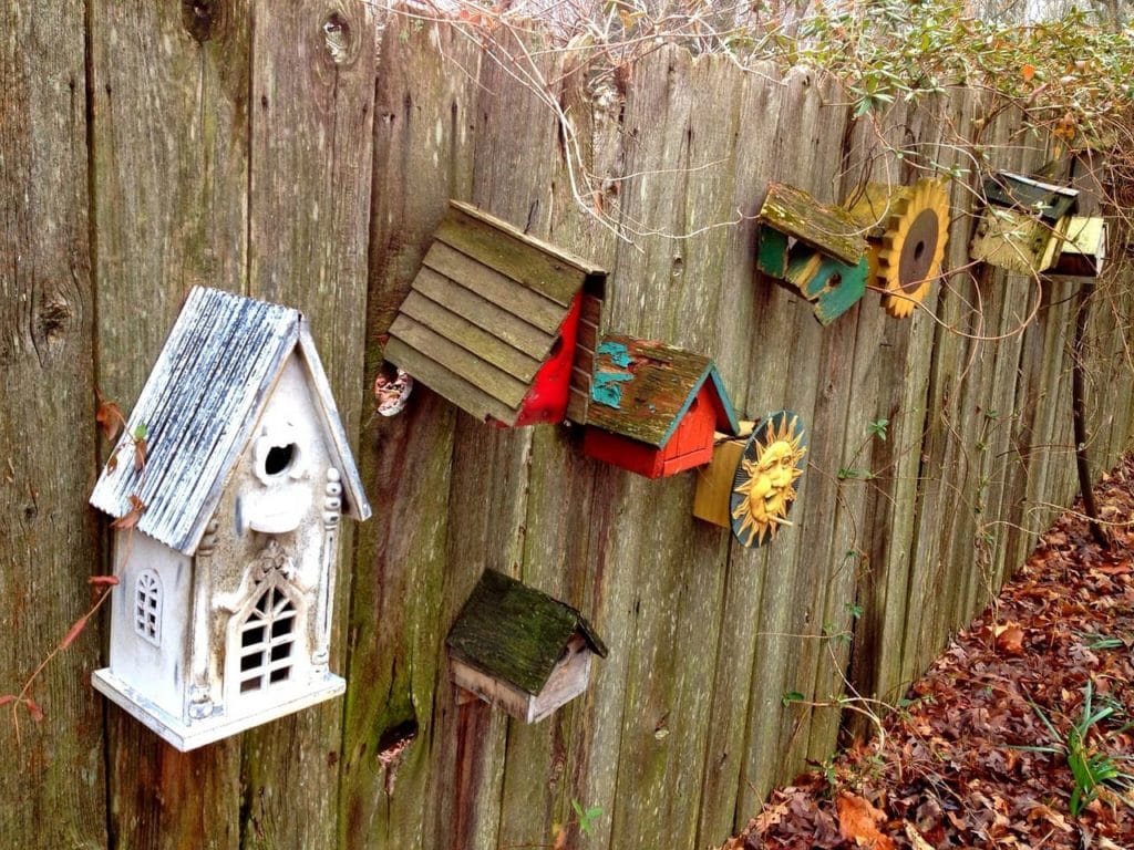 rustic birdhouses in the fence